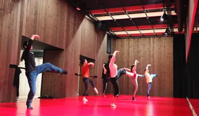 Personas bailando en una sala de ensayos